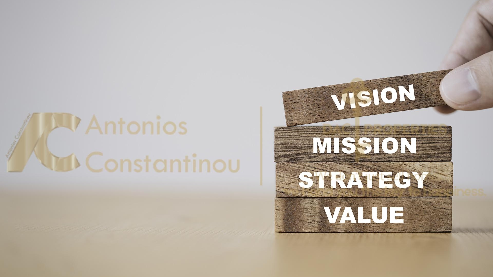Company key success concept , Hand putting wooden cubes blocks which print screen vision mission strategy and value wording.